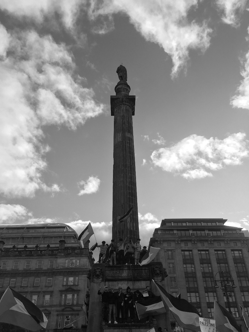 A tall monument with people standing around it AI-generated content may be incorrect.