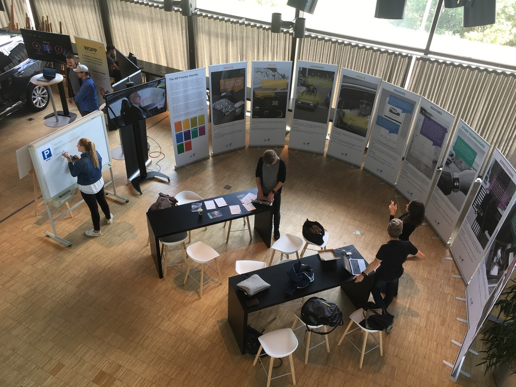 People standing in a semicircle of banners.