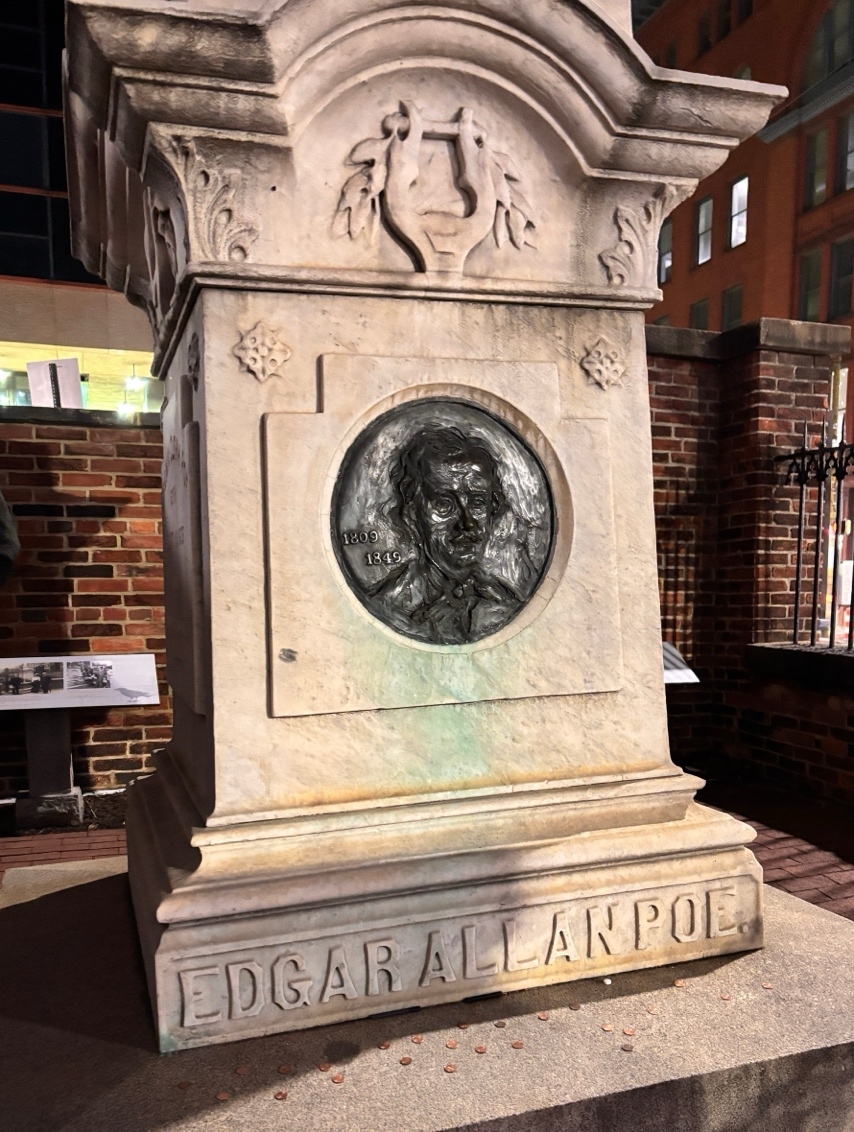 A stone monument with a picture of a person's face Description automatically generated