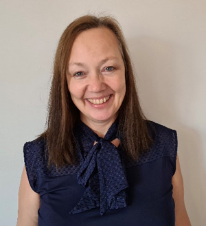 A person smiling at camera AI-generated content may be incorrect.