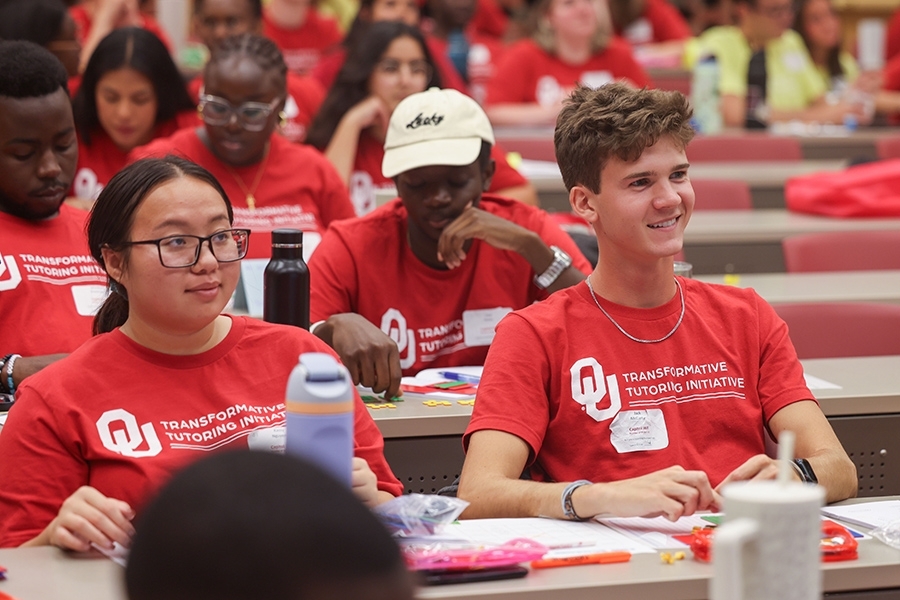 Tutor trainees smiling during President Joe Harroz's lecture.