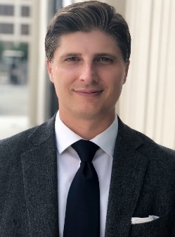A person in a suit and tie Description automatically generated
