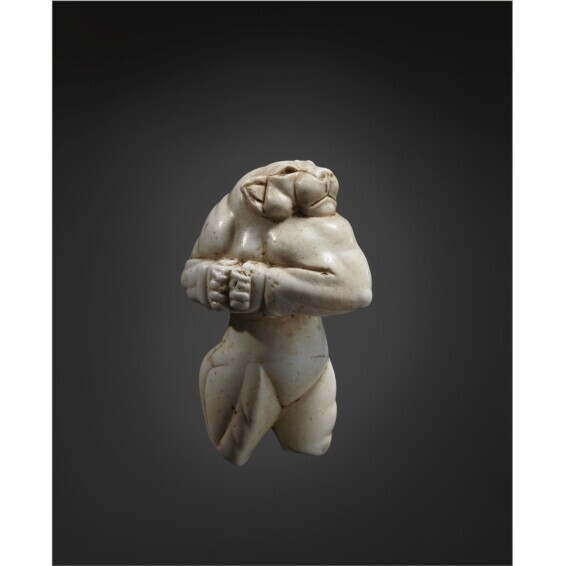 A statue of a person holding a towel AI-generated content may be incorrect.