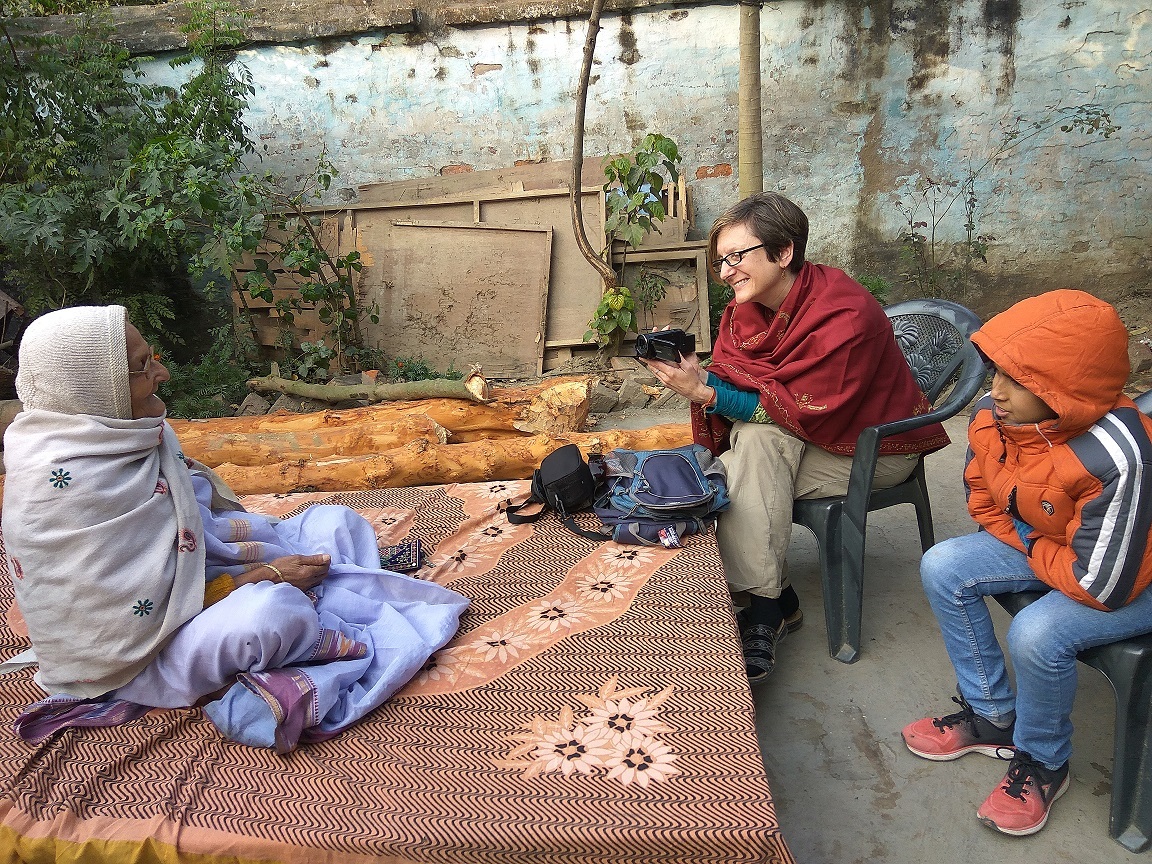 A group of people sitting outside AI-generated content may be incorrect.