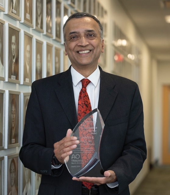 A person holding a glass award AI-generated content may be incorrect.