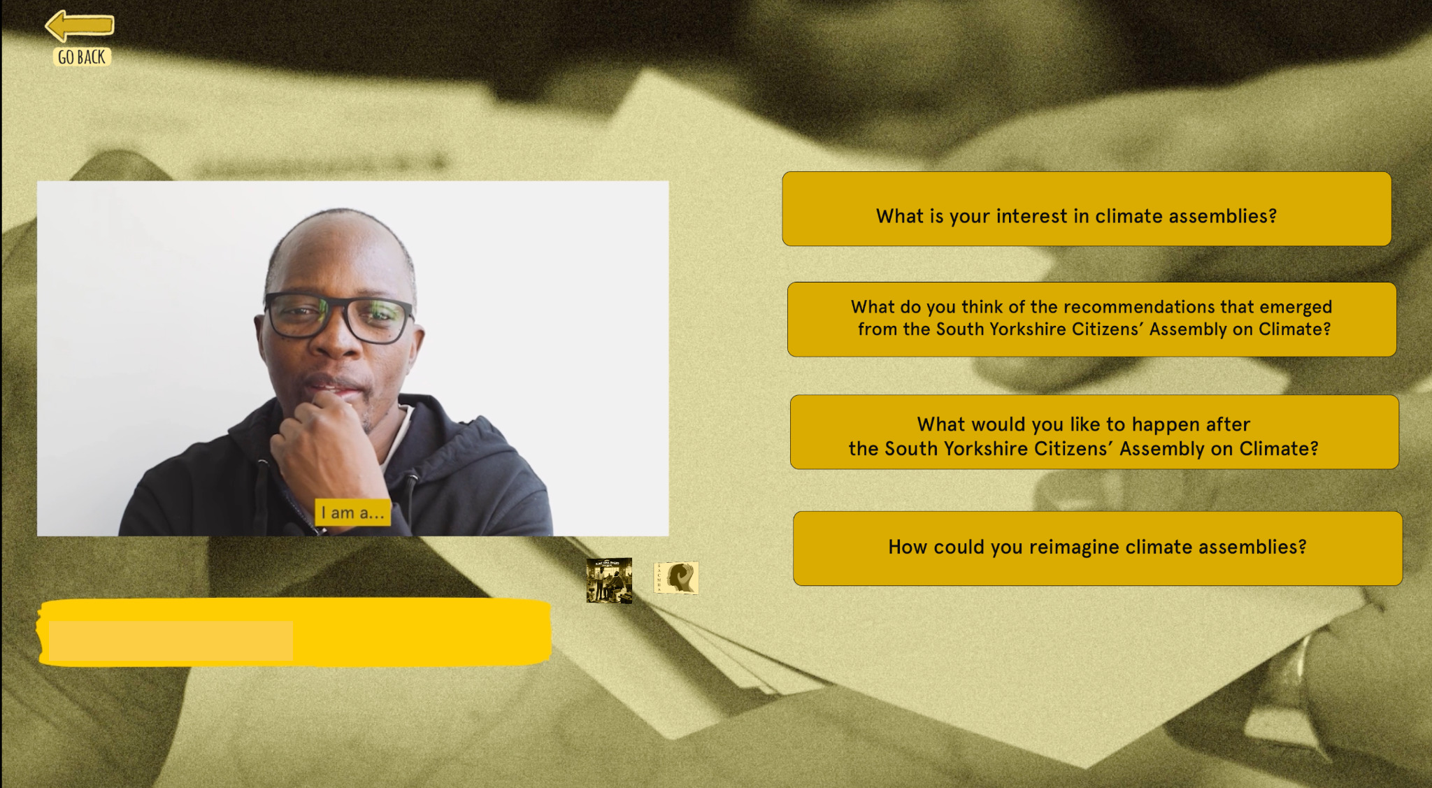i-Doc interface showing interview still of a black man being interviewed on one side, and a series of links to different questions on the other.