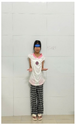 A child standing in front of a white wall AI-generated content may be incorrect.