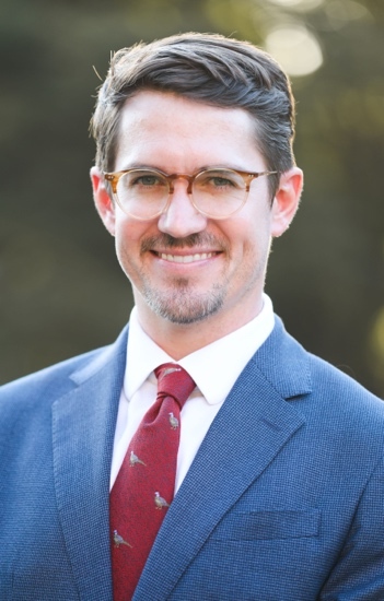 A person in a suit and tie AI-generated content may be incorrect.