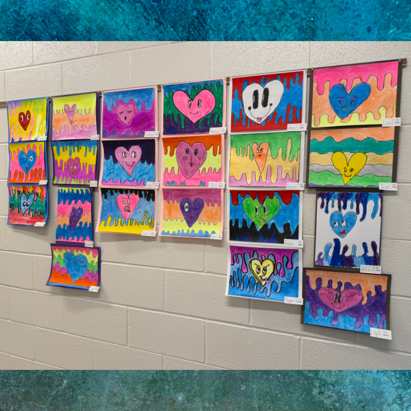 A wall display showcases numerous colorful heart drawings with various facial expressions.