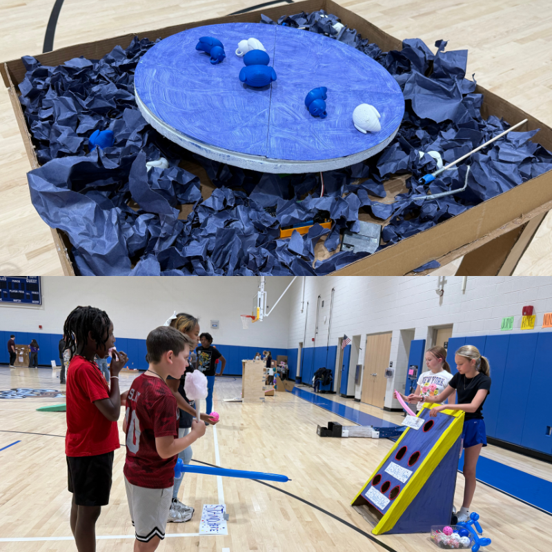 A diorama with a blue circular platform and blue and white figures sits in a cardboard box filled with crumpled blue paper.