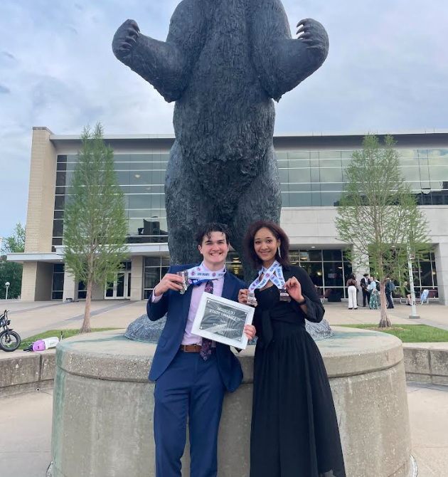 Dylan Rucinski and Shanelle Reynolds hold their medals and plaque after the MSHSAA Speech and Debate State Championship. 
