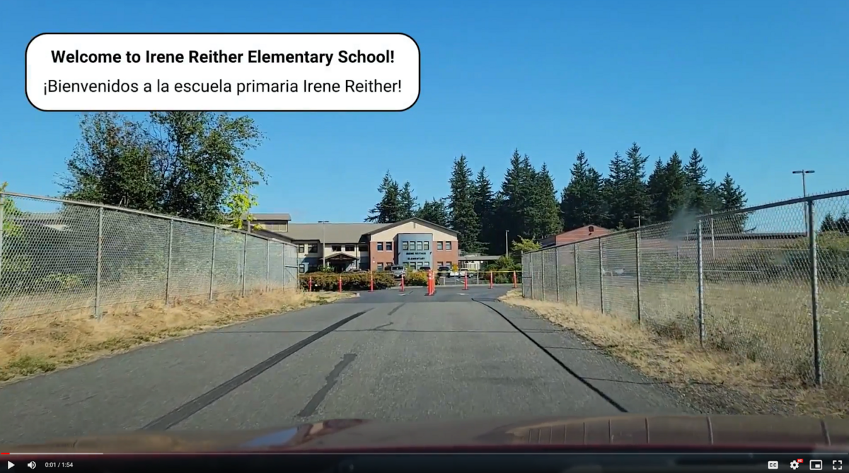 a road with a fence and a building on the side
