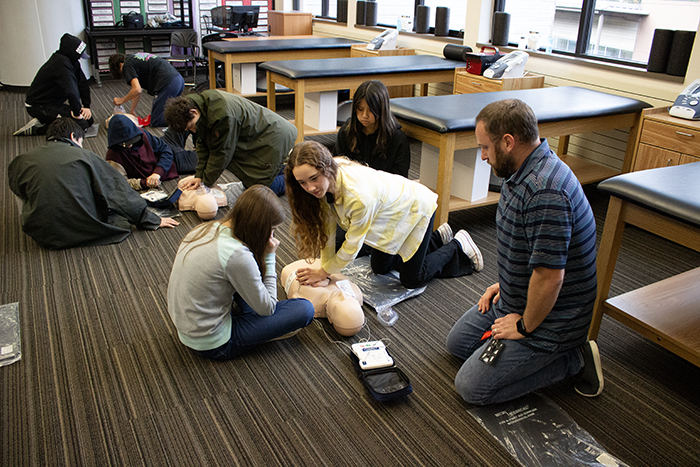 Students with a CPR dummy.