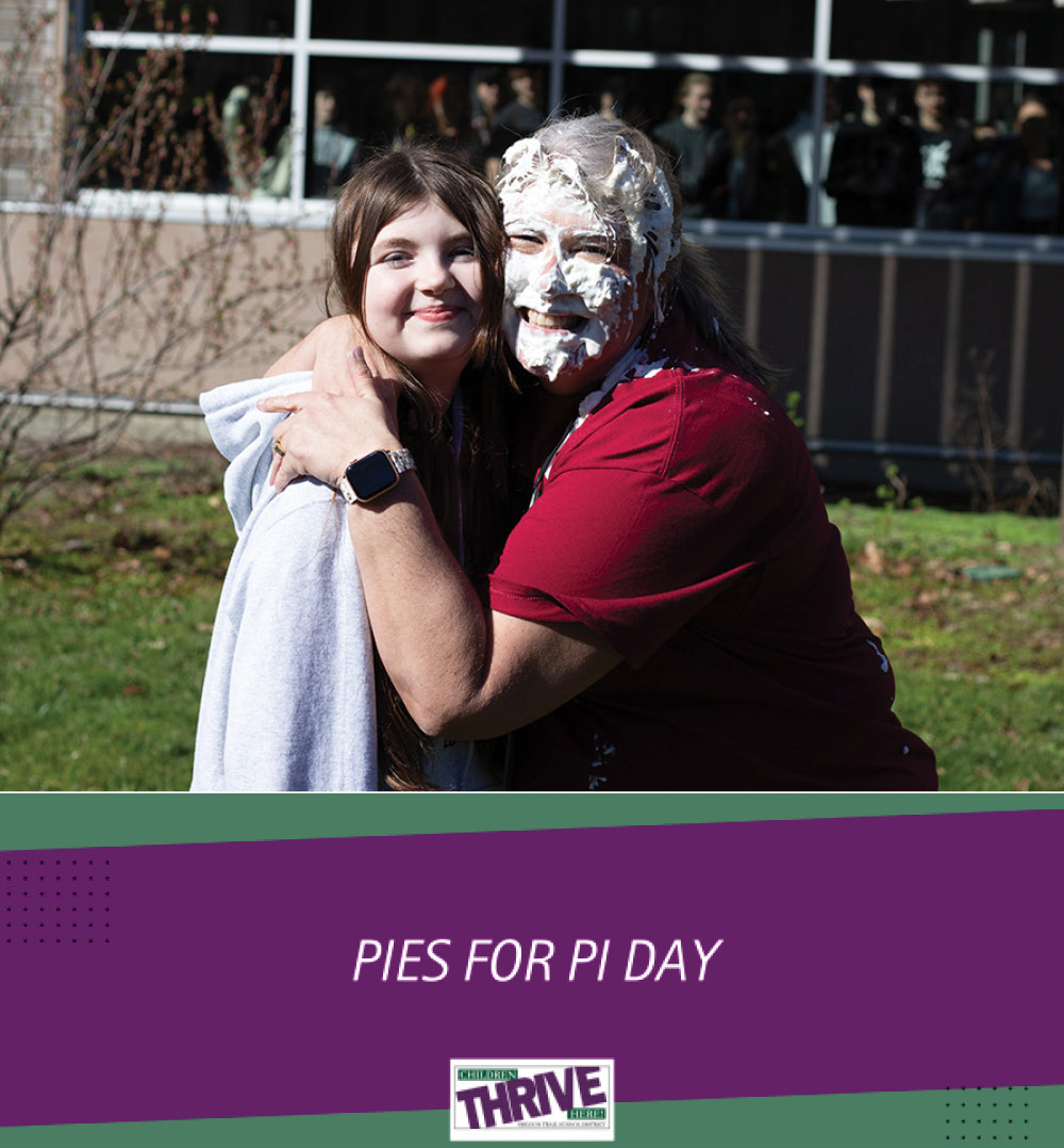 Sandy High School Principal Sarah Dorn embraces the student that smooshed a pie in her face on Pi Day.