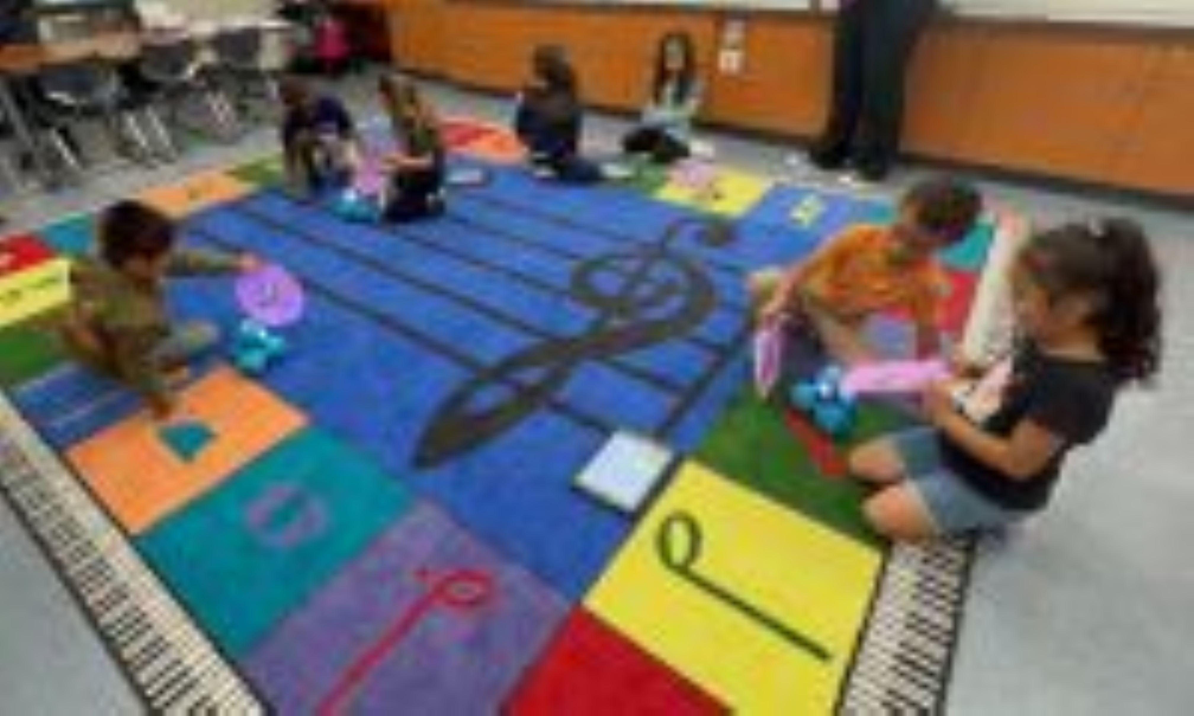 Students playing with robots and their monsters.