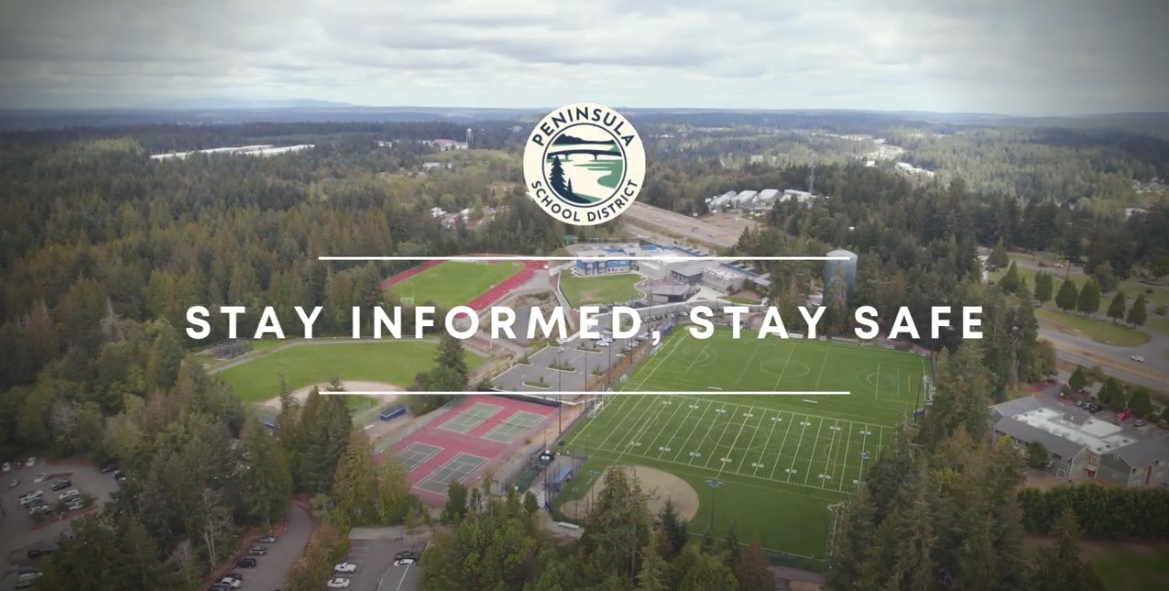 Aerial view of Peninsula School District campus, featuring sports fields, tennis courts, and surrounding greenery. The image includes the district logo at the top center and the text 'Stay Informed, Stay Safe' displayed across the middle.
