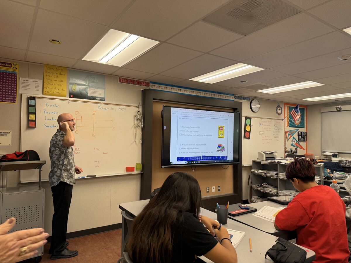 Image of teacher providing instruction to students in new B-Wing classroom.