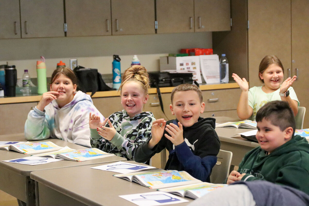 Students in Jim Cassella’s class celebrate after correctly guessing where their distance learning partners were located.