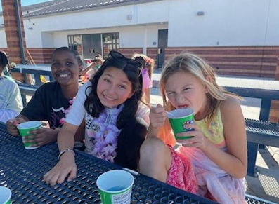 Image of two students enjoying a refreshing Kona Ice treat.