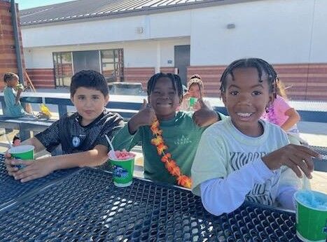 Image of three students enjoying a refreshing Kona Ice treat.