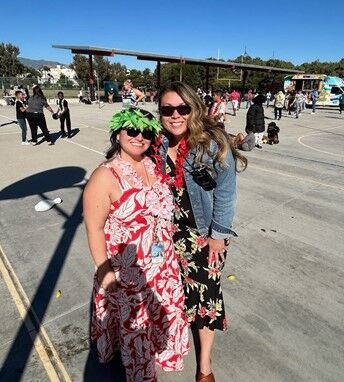 Image of two teachers in their luau-themes attire.