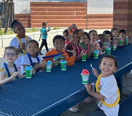 Image of a table full of students enjoying their Kona Ice treat.