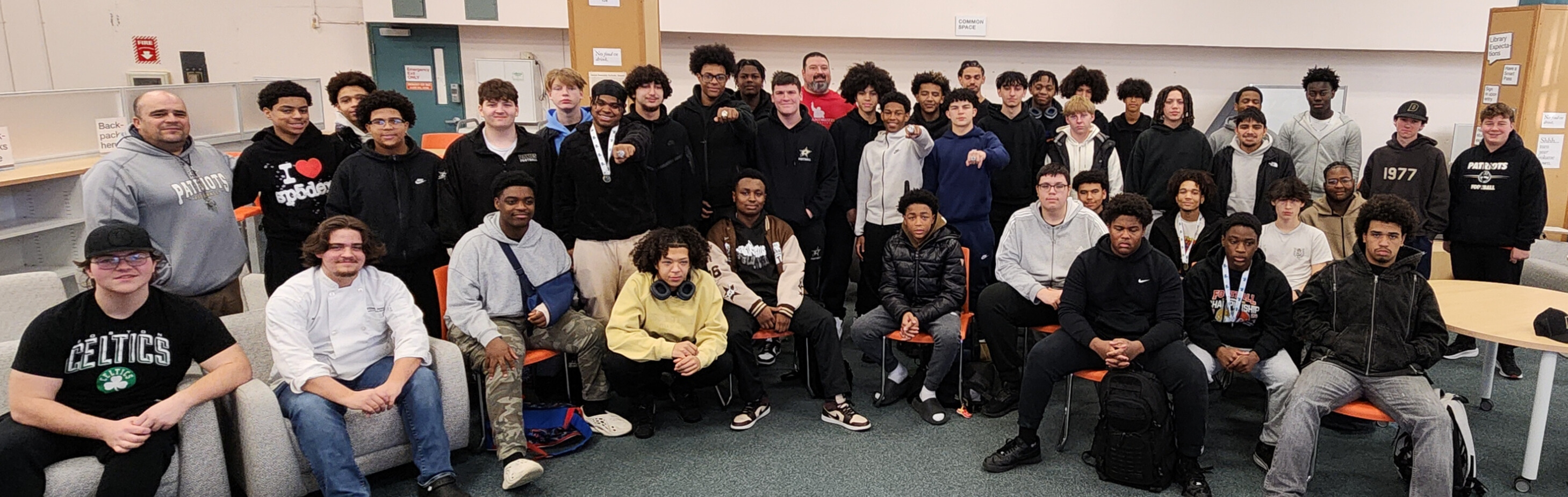 Coach Cabral, the Davies' Patriots, and Joe Andruzzi pose for a photo.
