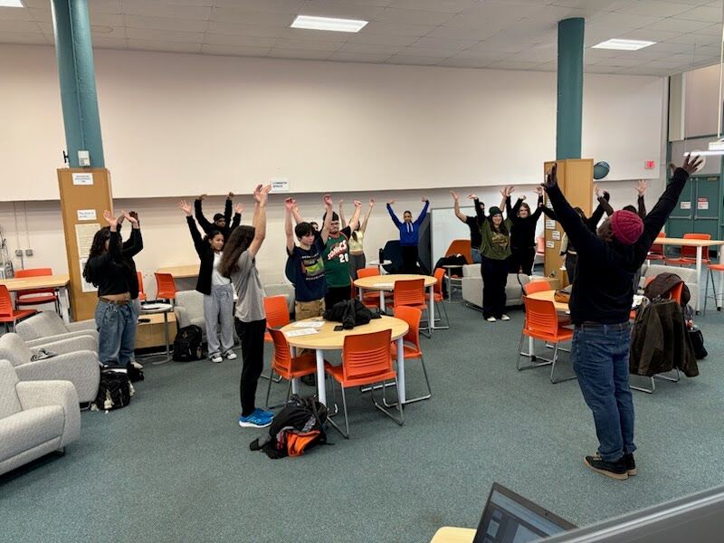 Students stretching with visitors.