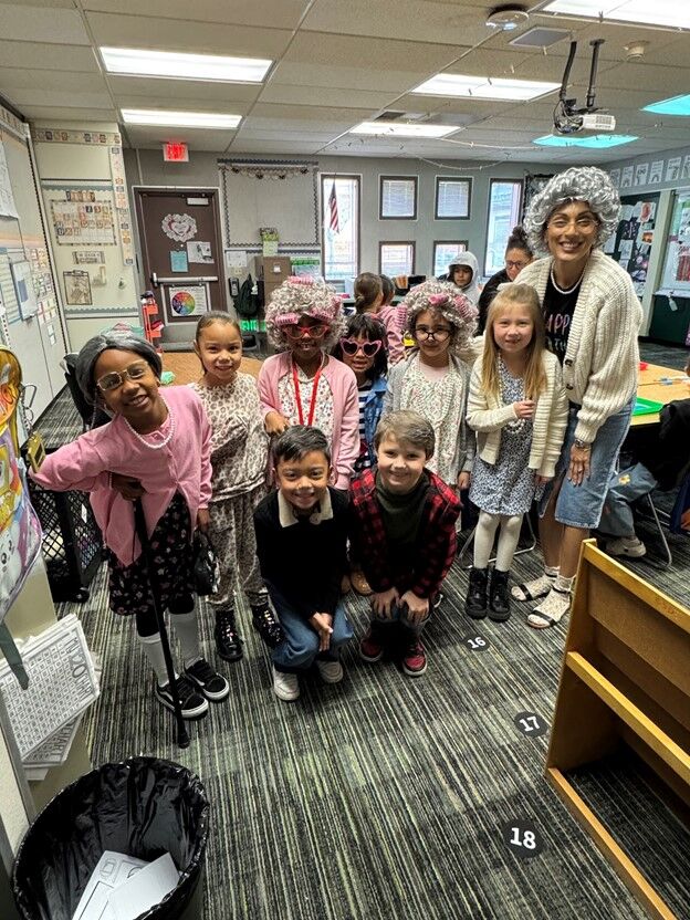 Image of teacher with her students dressed in costumes inspired by senior citizens