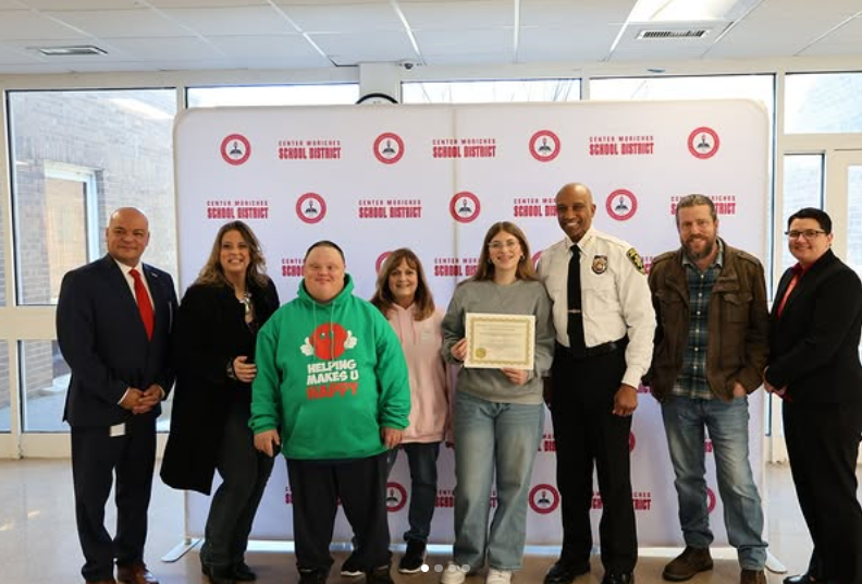 Kayla being presented with her award