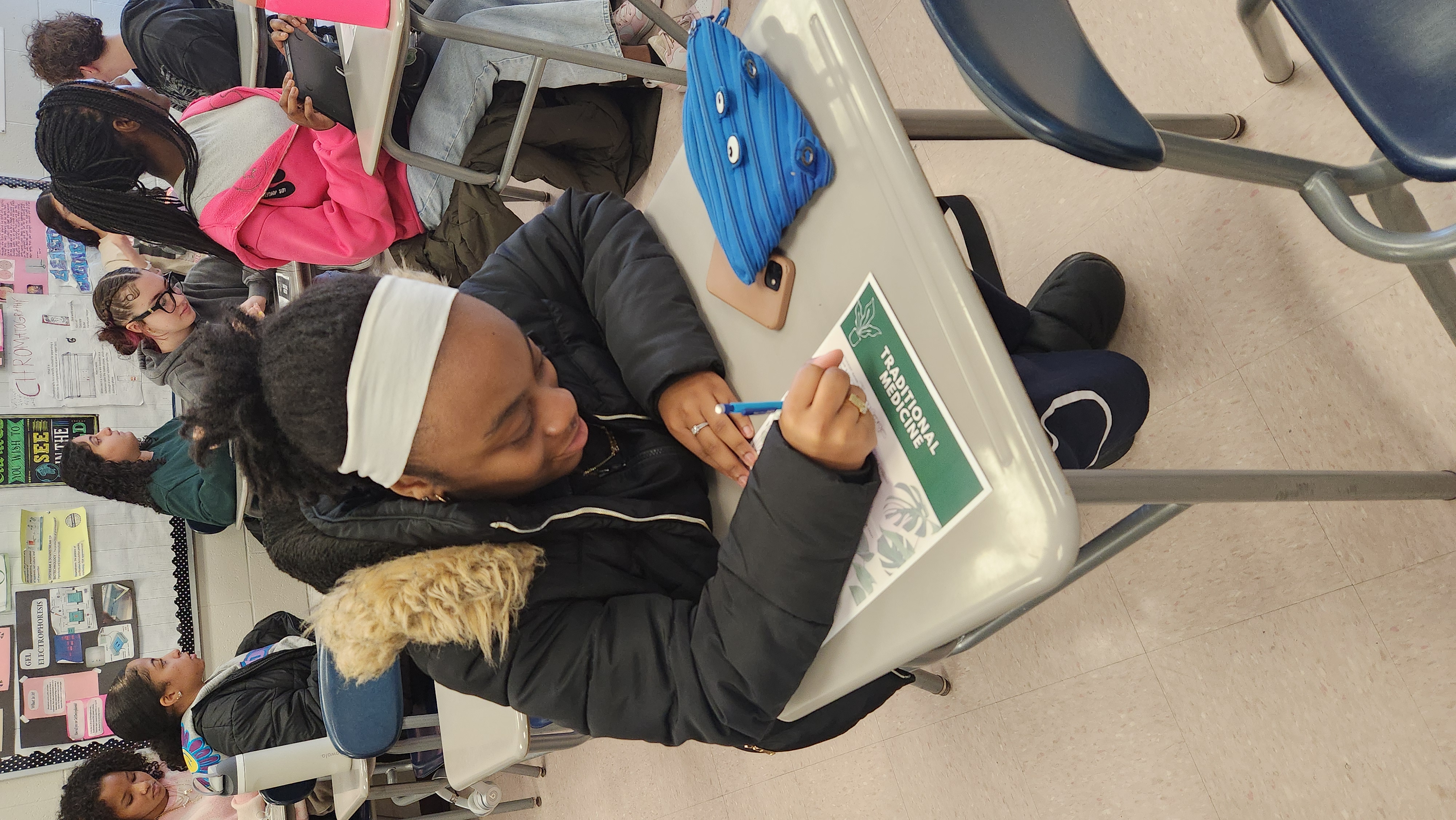 Gianna works on a handout distributed by the visitor.