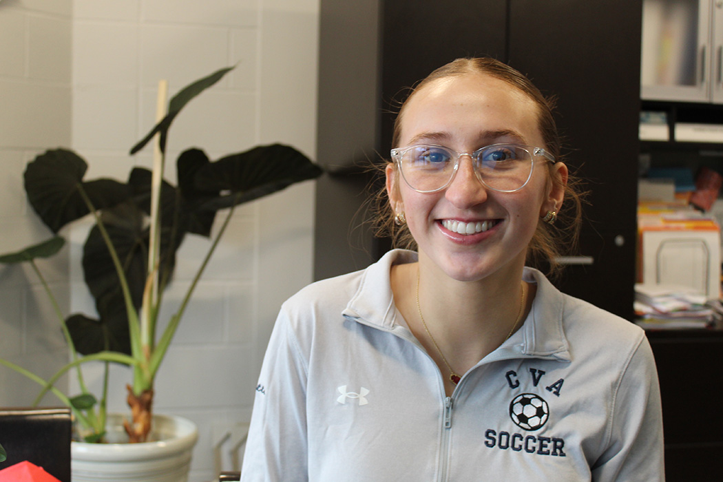 Closeup of girl smiling, glasses, CVA soccer logo on polo shirt