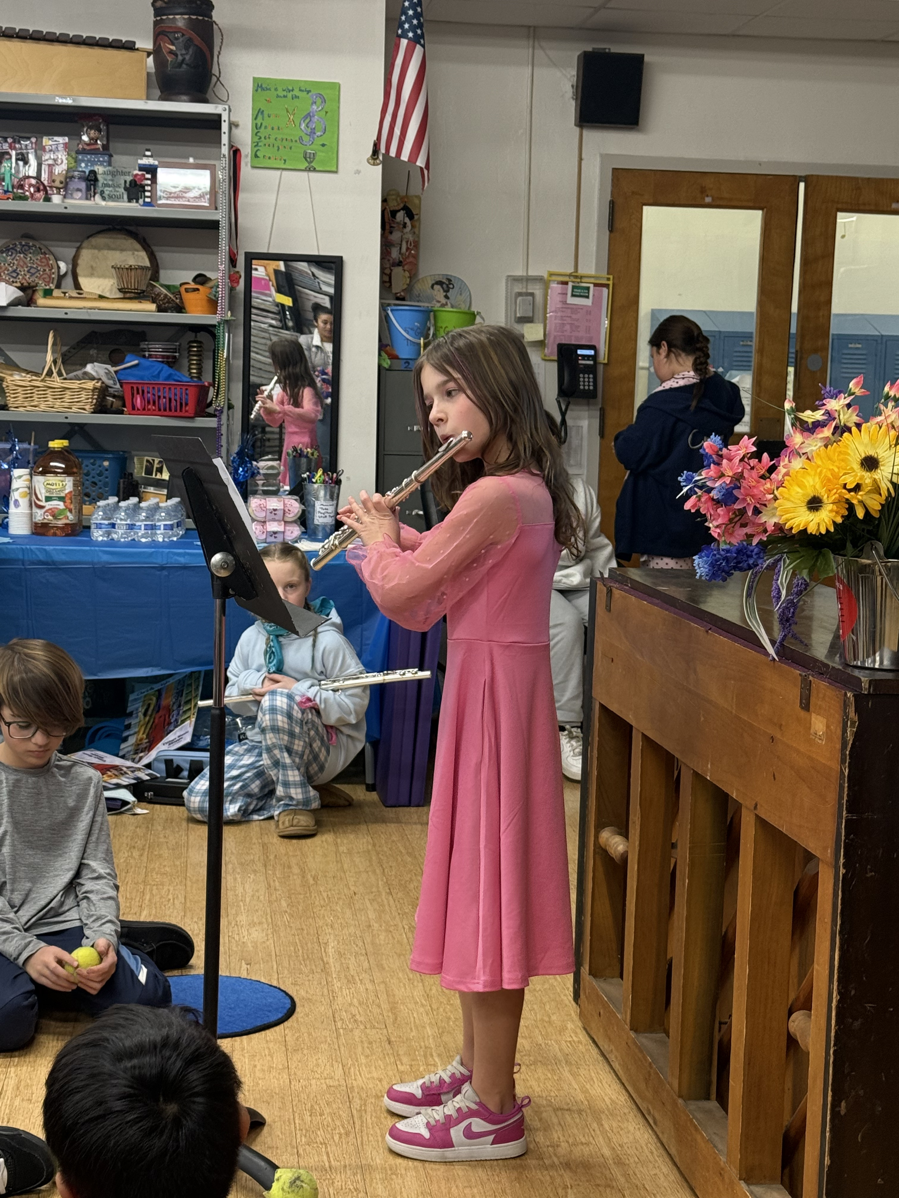 A student playing the flute at the Young Composers Showcase