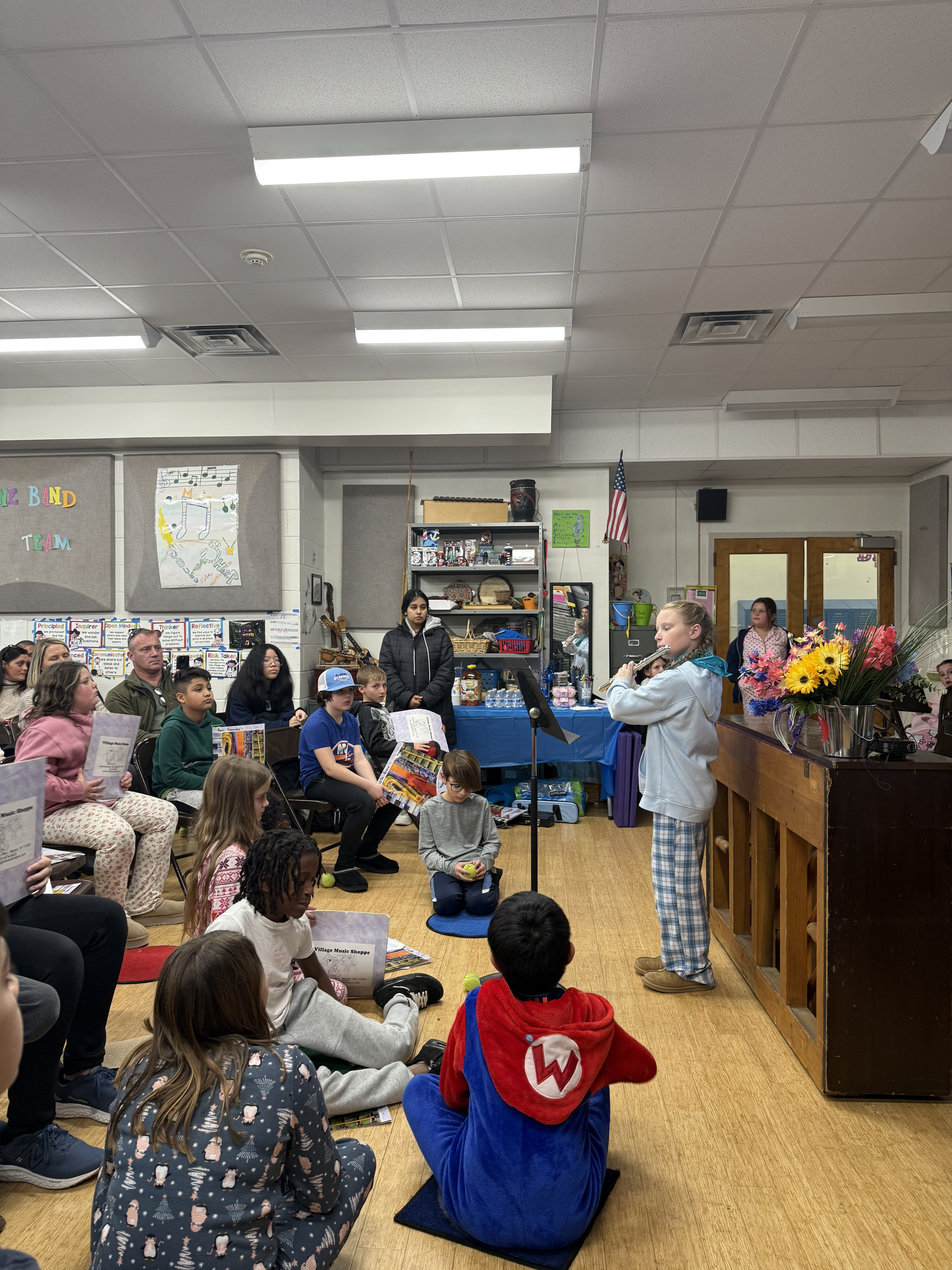 A student playing the flute at the Young Composers Showcase