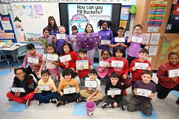 Mrs. Dooley's class dressed in pink and purple.