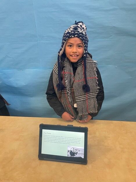 Image of a CES 3rd Grade Student with a project display.