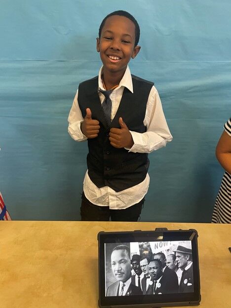 Image of a CES 3rd Grade Student with a project display.