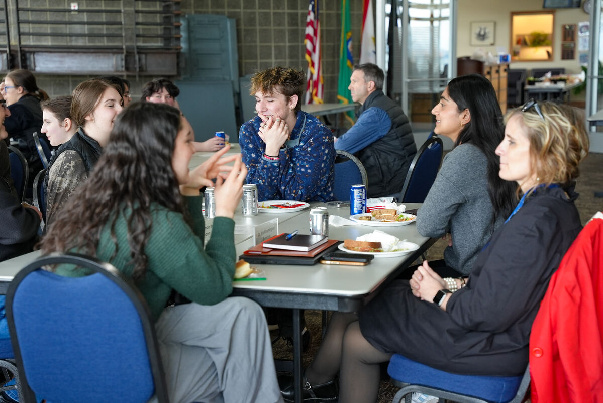 a group of students talk over lunch with superintendents