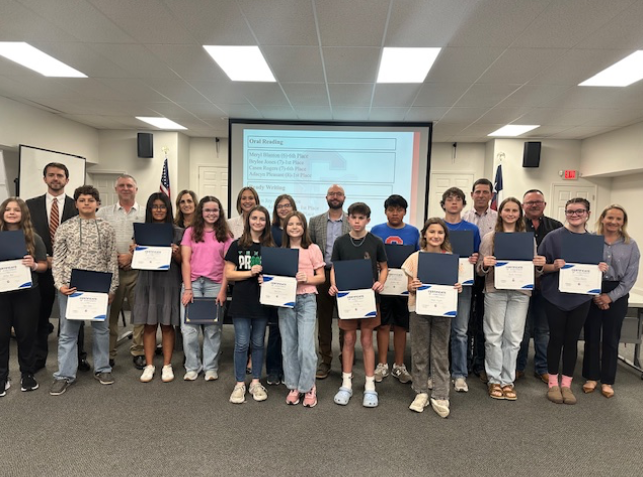 Group of students Junior High District Academic UIL Winners at the board meeting with their awards
