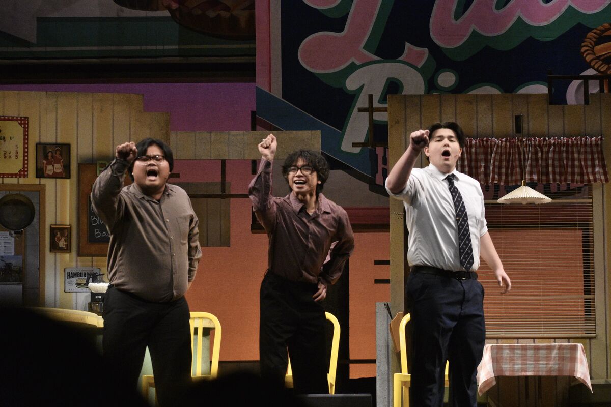 students performing on stage