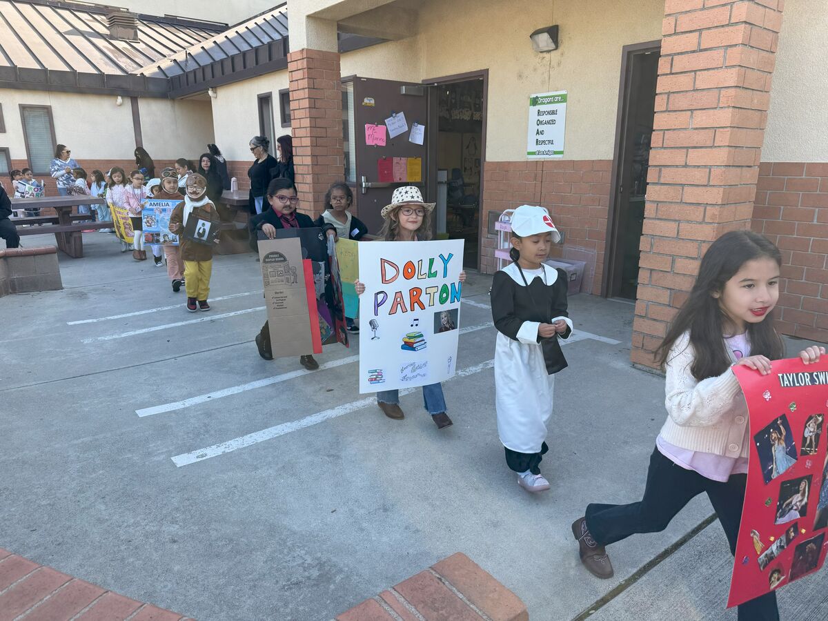 Image of students showcasing their vibrant posters during History Day at Los Amigos Elementary School.