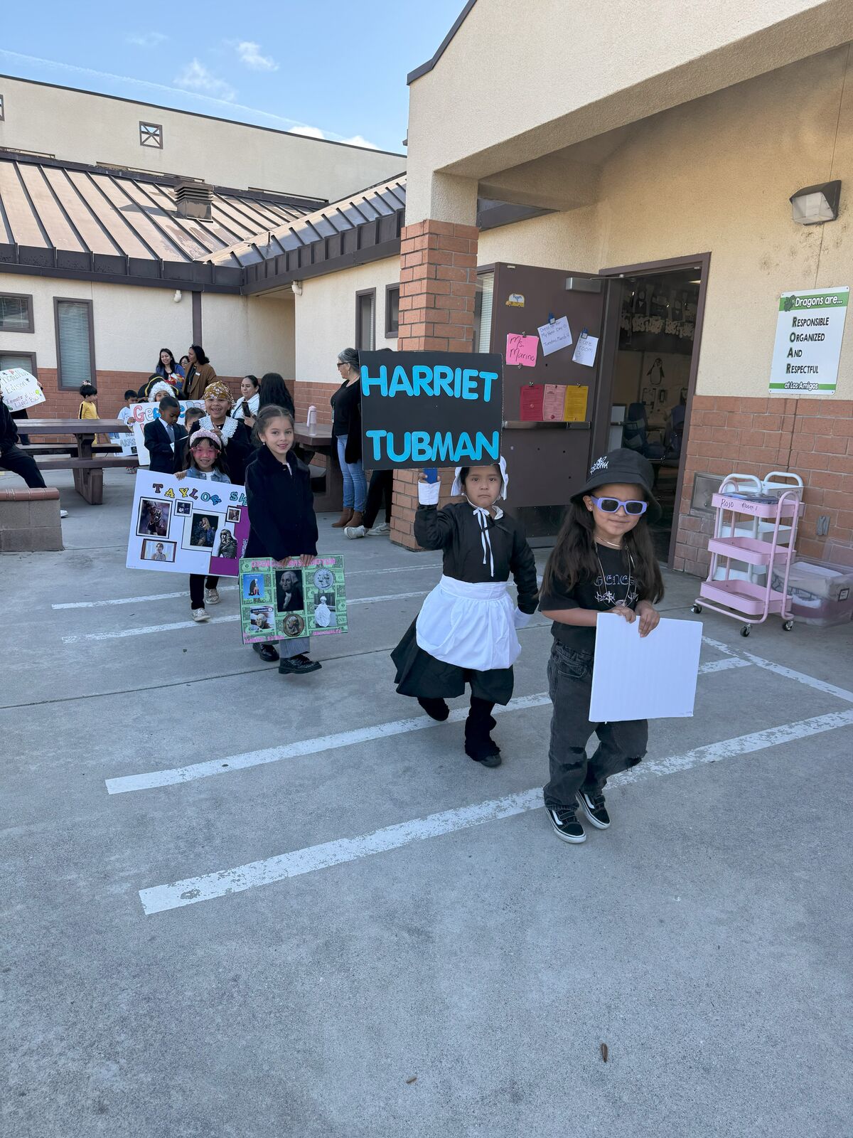 Image of students showcasing their vibrant posters during History Day at Los Amigos Elementary School.