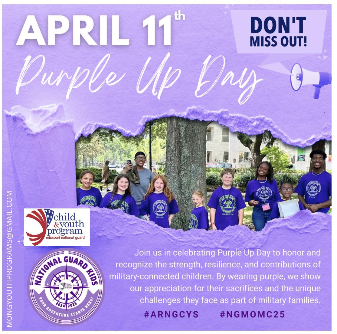 A group of children wearing purple shirts stand in front of a tree, celebrating Purple Up Day to honor military families.