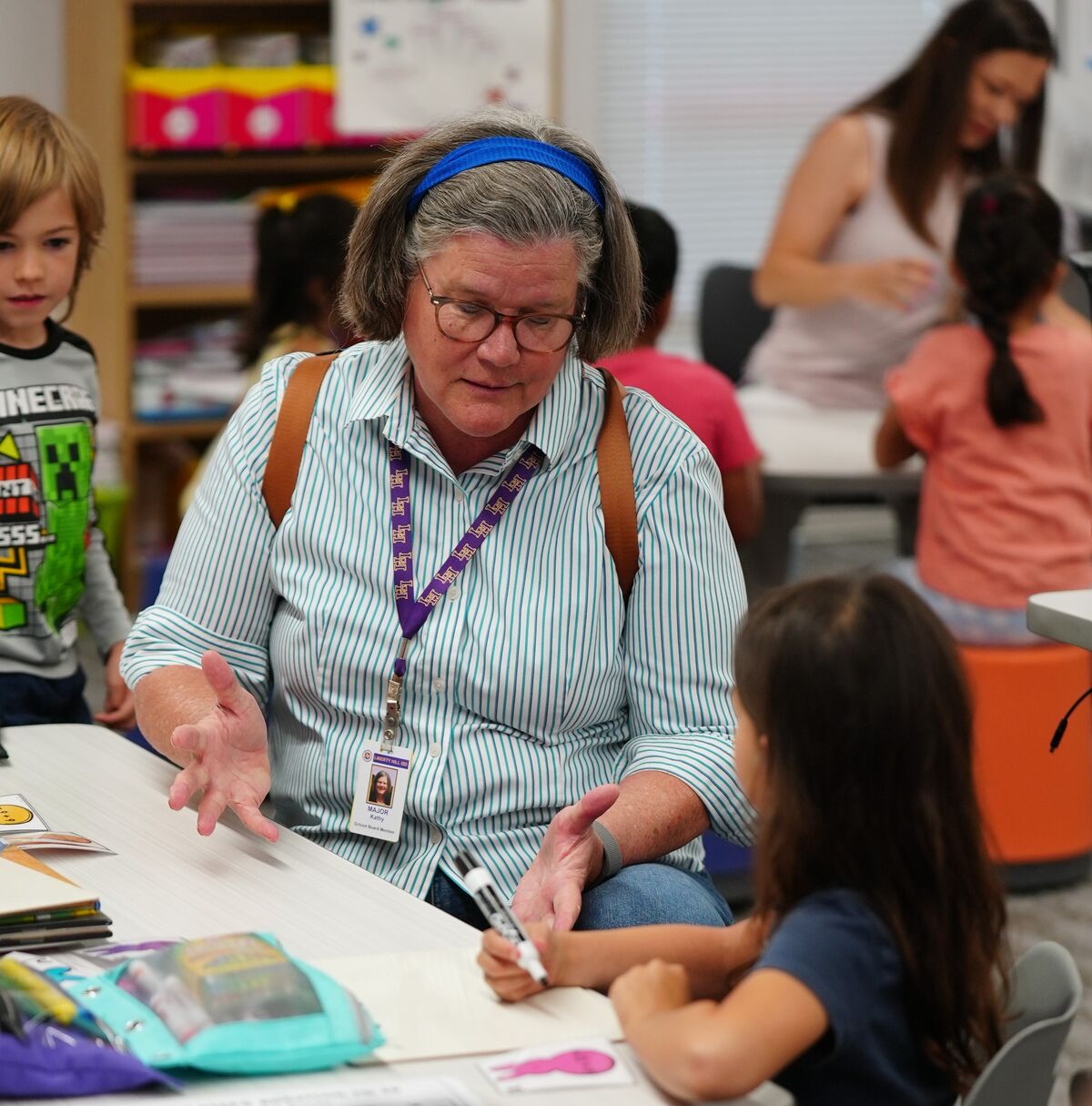 Kathy Major speaking with a child