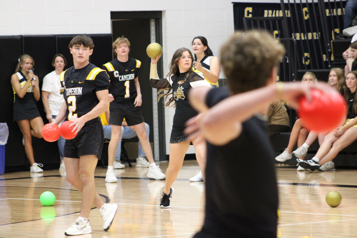Junior and senior students play a game of dodgeball in the gym