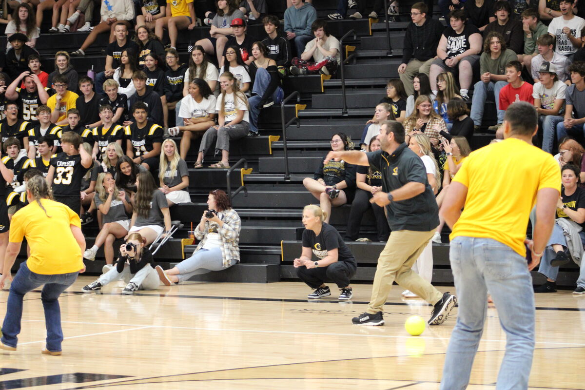 Staff members take on students in a dodgeball game at the pep rally