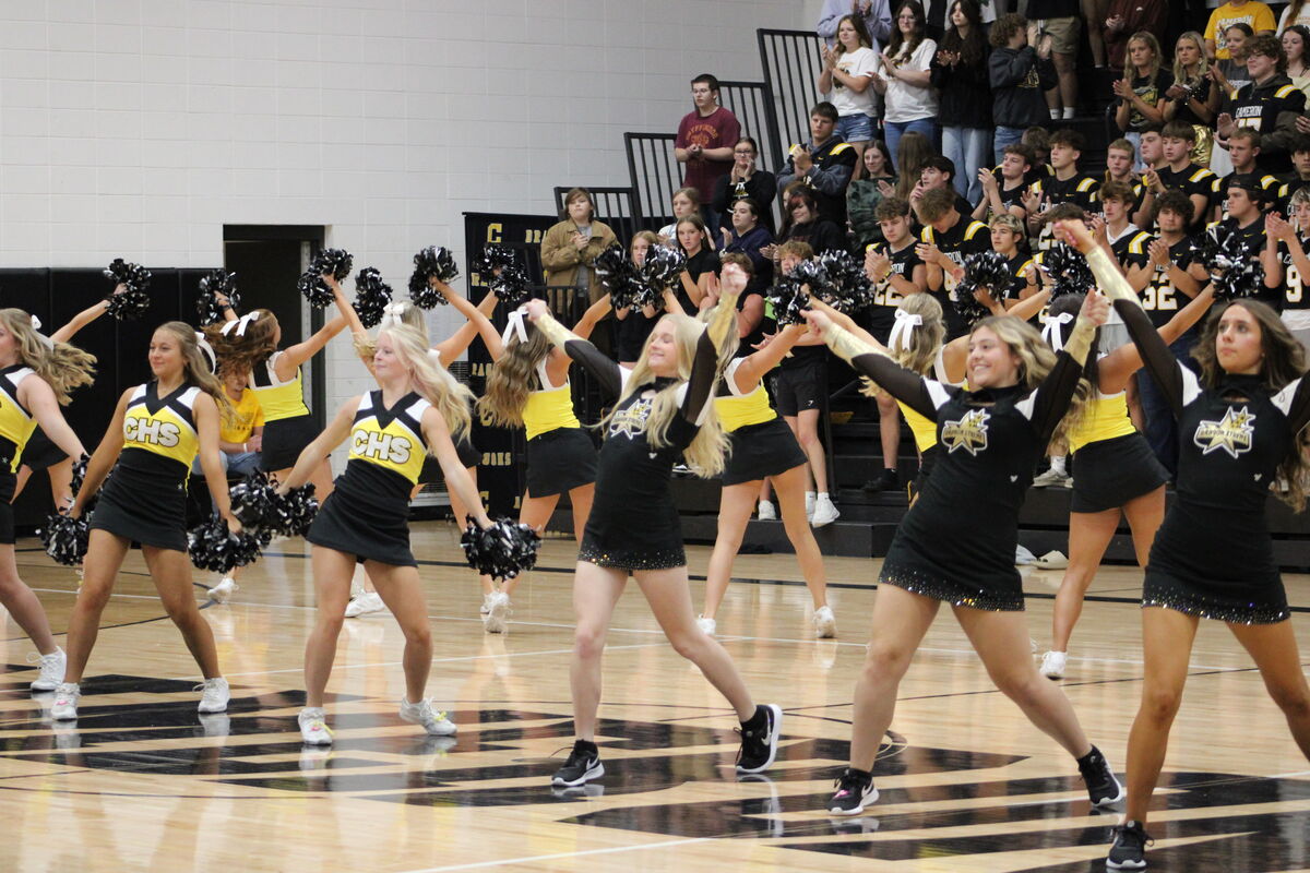 Cheer team performs in the gym for the pep rally