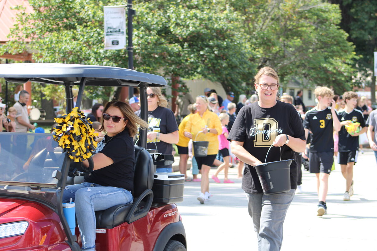 Board of education members pass out candy in the homecoming parade