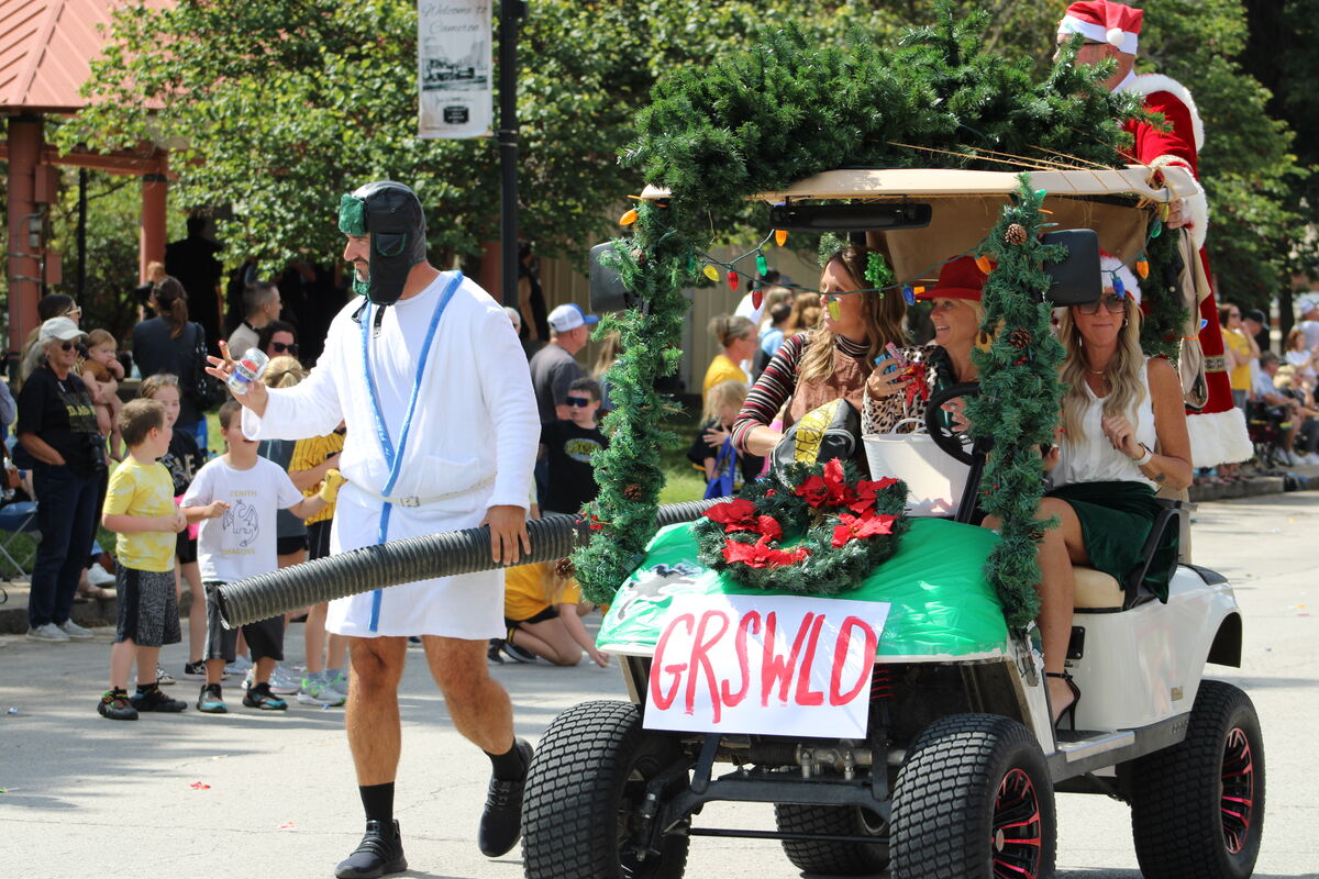 High school staff dressed as characters from a Christmas movie participate in the parade