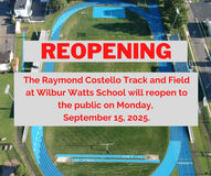 An aerial view of a track and field with text announcing its reopening.